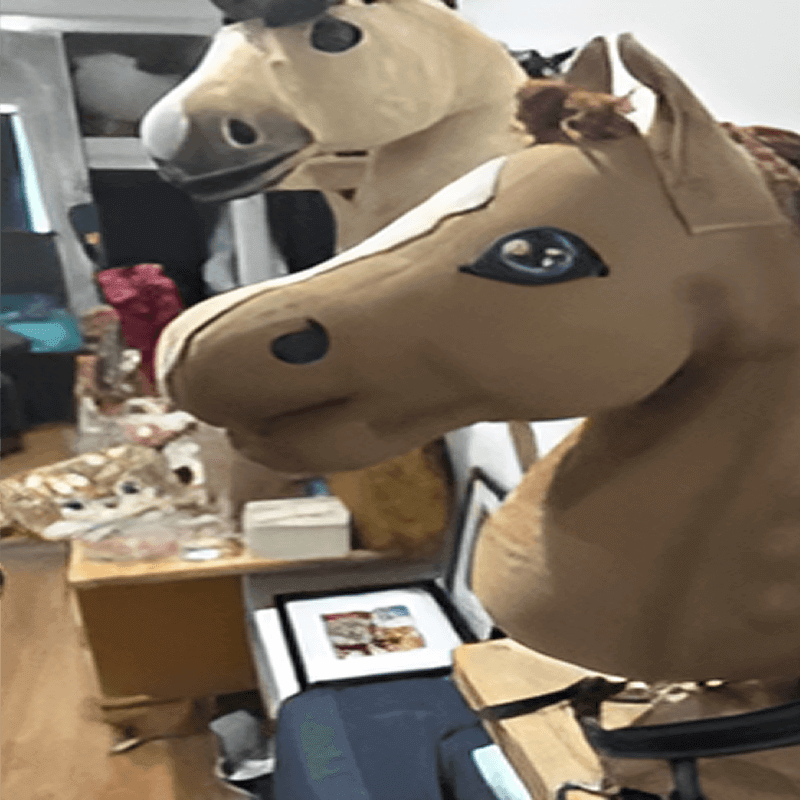 Two large horse head costumes displayed on mannequins in a cluttered room with various items and framed pictures.