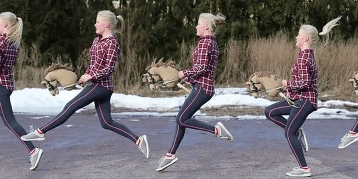 Person wearing plaid shirt and pants running in sequence while holding a toy hobby horse, appearing in motion across a paved surface with grass and snow in the background.