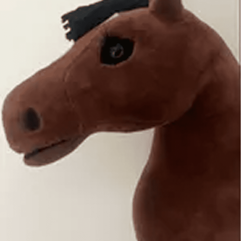 Brown plush horse toy against a plain background.
