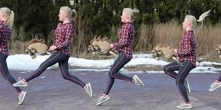 Two women in plaid shirts running outdoors on a chilly day.
