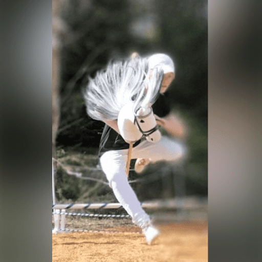 Baseball player in mid-pitch wearing white and black uniform.